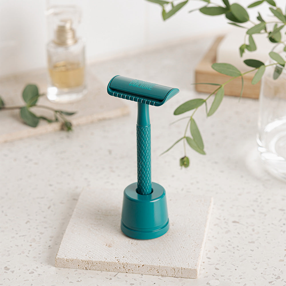 
                  
                    diamond grip jungle culture reusable razor in teal on stand
                  
                
