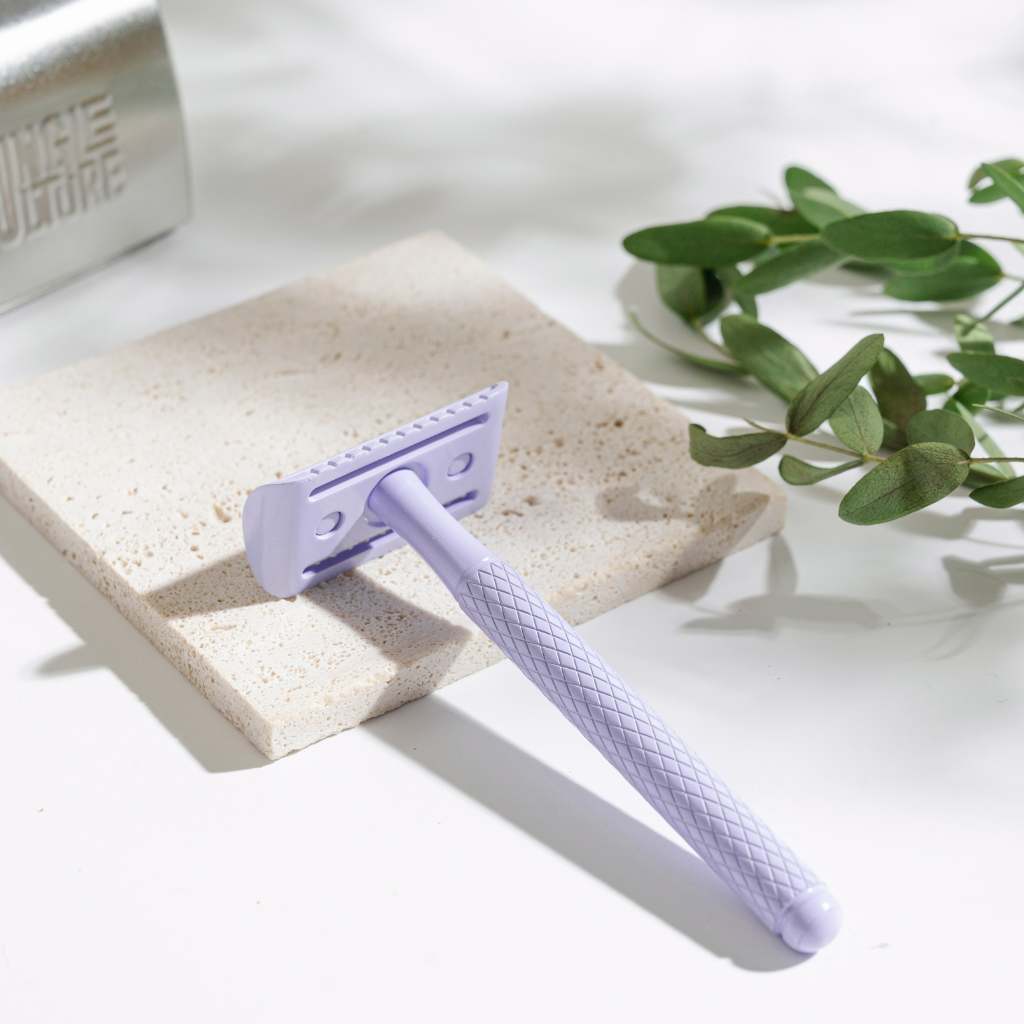 
                  
                    lilac reusable razor on stone
                  
                