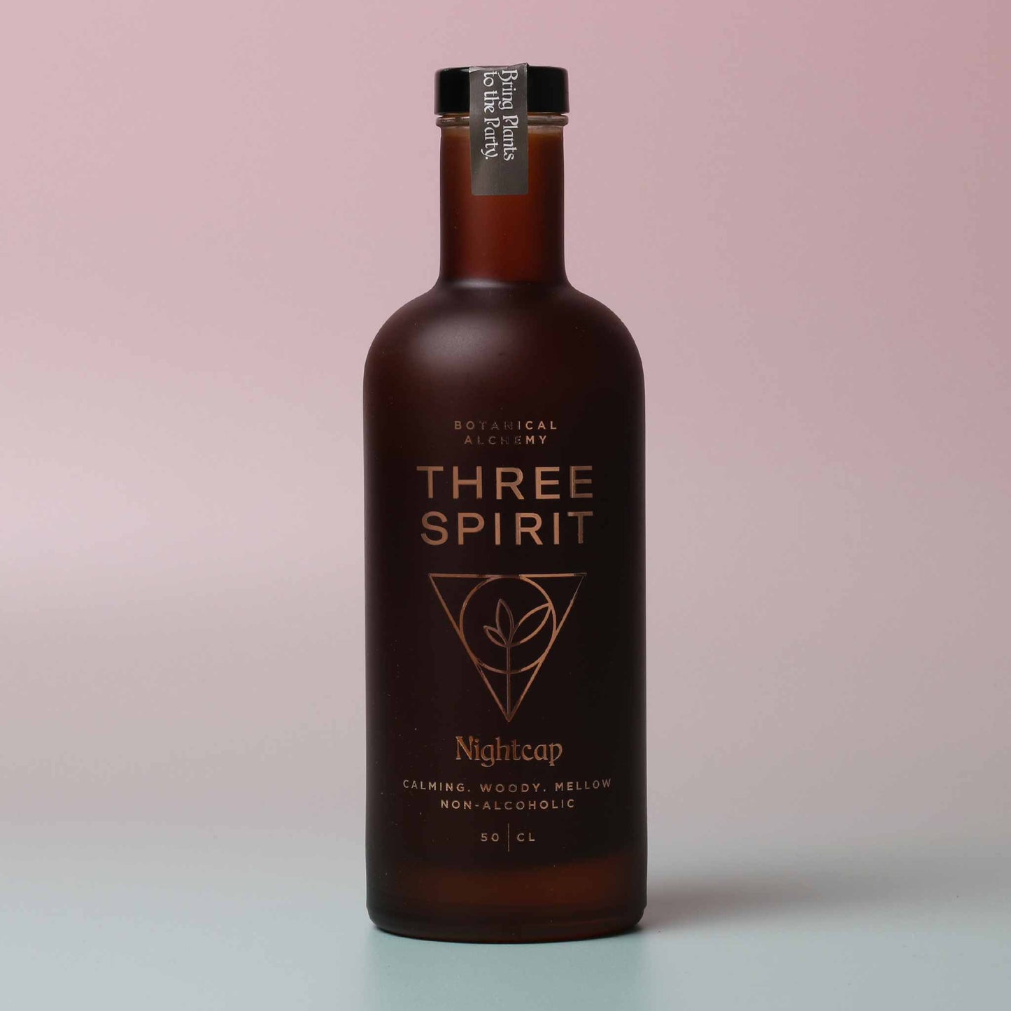 three spirit nightcap calming non-alcoholic drink bottle on pink